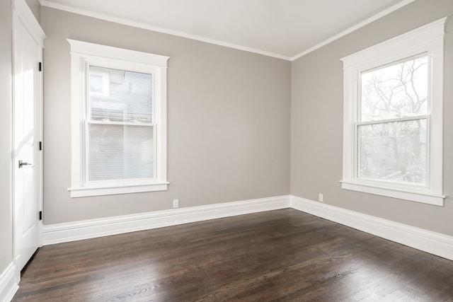 empty room with crown molding, dark hardwood / wood-style floors, and a healthy amount of sunlight