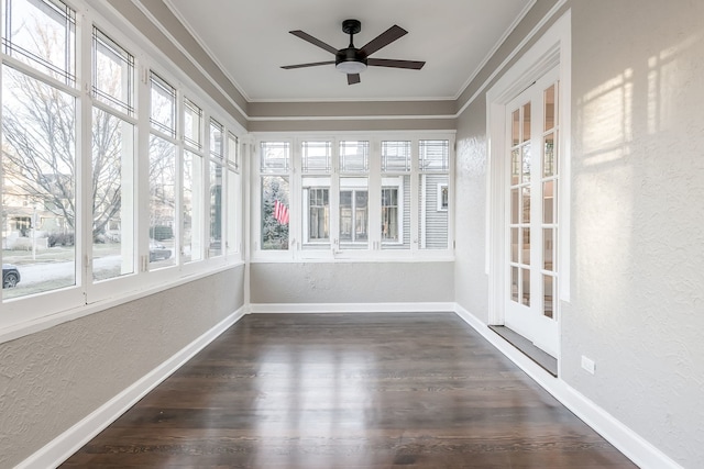 unfurnished sunroom featuring ceiling fan