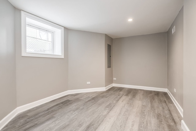 spare room featuring light hardwood / wood-style flooring and electric panel