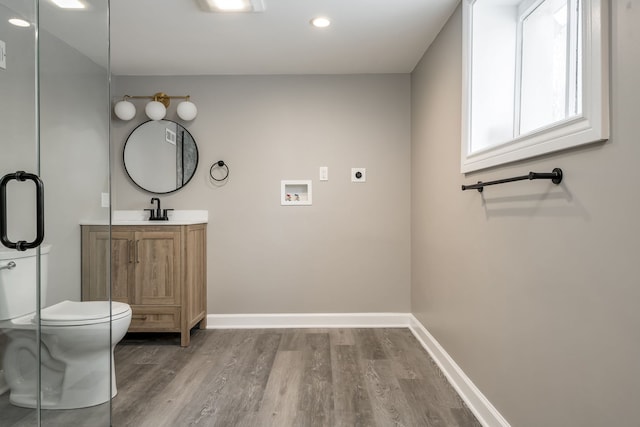 bathroom featuring hardwood / wood-style floors, vanity, and toilet