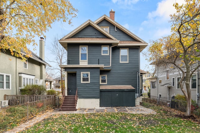 rear view of house with a yard