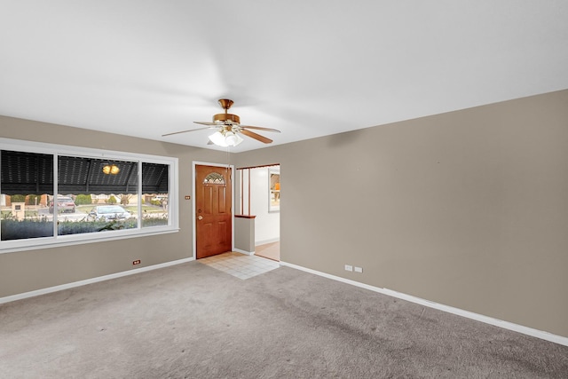 spare room featuring light carpet and ceiling fan