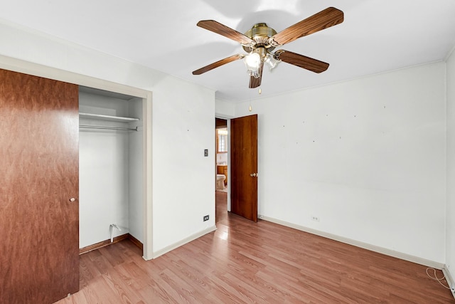 unfurnished bedroom with a closet, light hardwood / wood-style floors, and ceiling fan