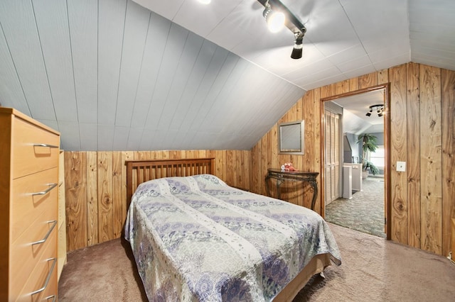 bedroom featuring wood walls, carpet, and lofted ceiling