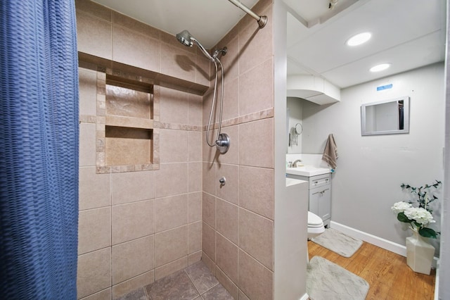 bathroom with toilet, vanity, wood-type flooring, and walk in shower