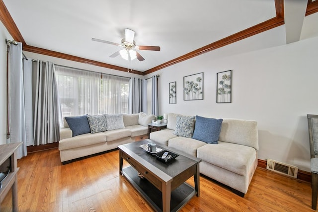 living room with ceiling fan, hardwood / wood-style floors, and ornamental molding