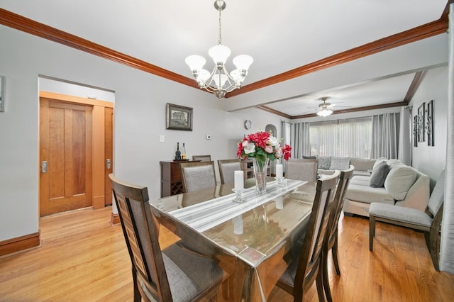 dining area with light hardwood / wood-style floors, ceiling fan with notable chandelier, and ornamental molding