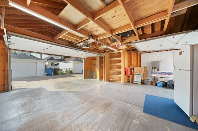 garage with white fridge and a garage door opener