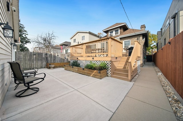 exterior space with a patio area and a wooden deck