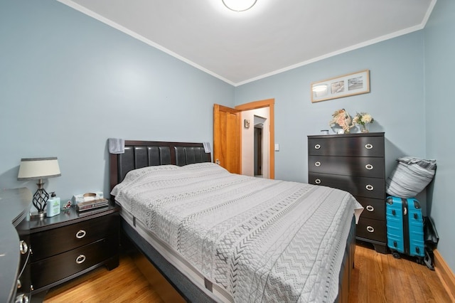 bedroom featuring light hardwood / wood-style floors and ornamental molding