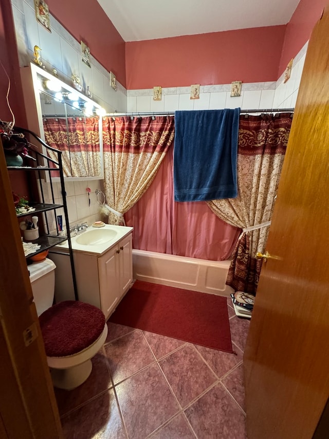 full bathroom with tile patterned floors, shower / bathtub combination with curtain, vanity, and toilet