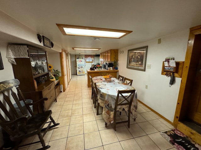 dining space featuring light tile patterned flooring