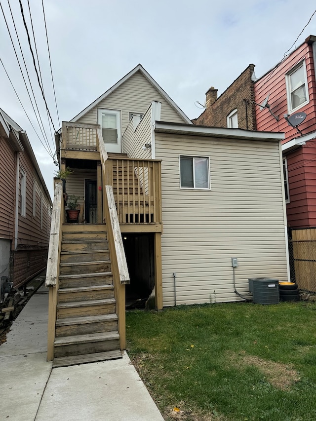 rear view of property with a lawn and central AC