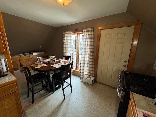 dining space with vaulted ceiling