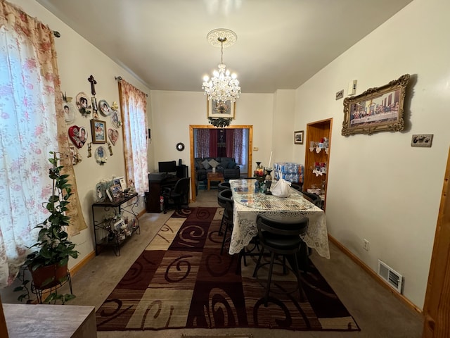 dining room featuring carpet floors and an inviting chandelier