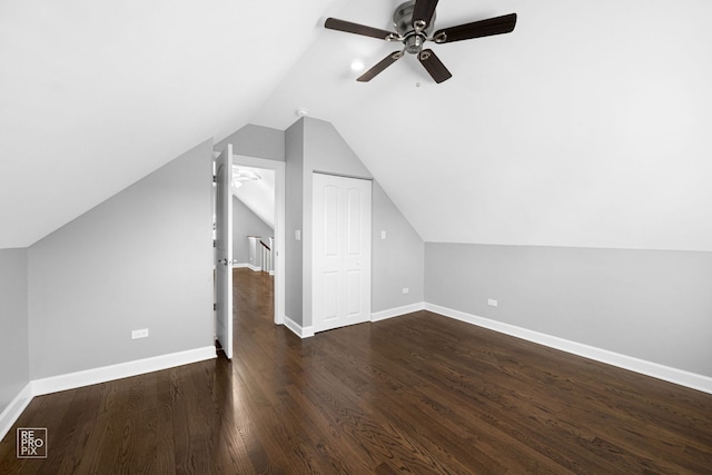 additional living space with ceiling fan, dark hardwood / wood-style flooring, and lofted ceiling