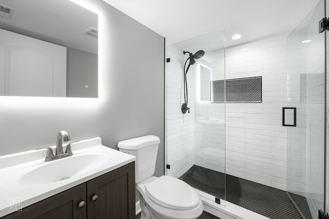 bathroom with vanity, toilet, and walk in shower