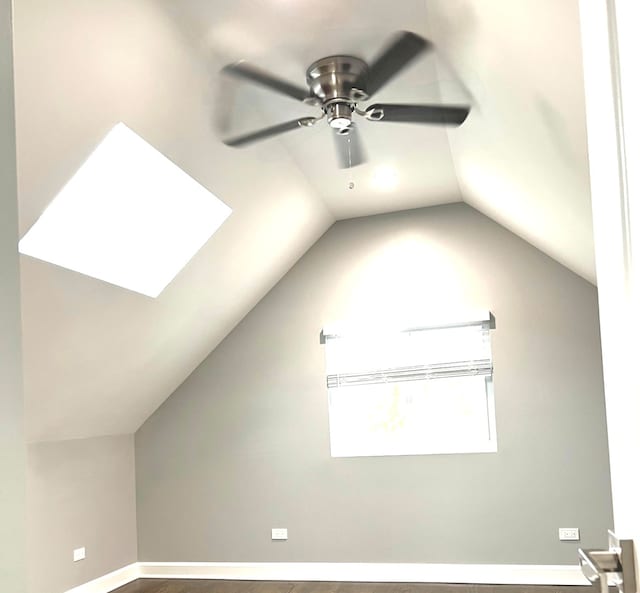 interior space featuring ceiling fan and a skylight