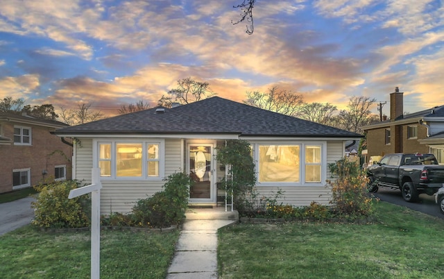 bungalow-style house with a yard