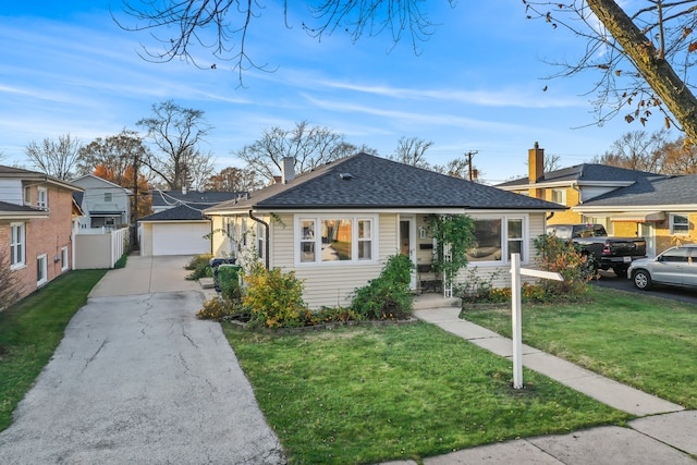 ranch-style home featuring an outbuilding, a garage, and a front lawn