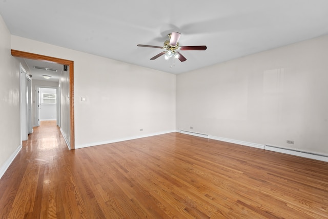 unfurnished room with ceiling fan, baseboard heating, and light hardwood / wood-style flooring