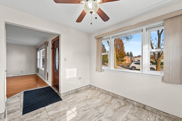 unfurnished room with ceiling fan, light hardwood / wood-style flooring, and a baseboard heating unit