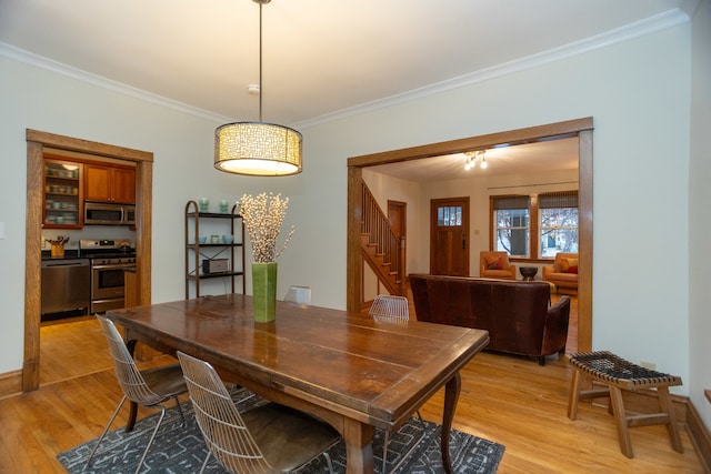 dining space featuring a wealth of natural light, a fireplace, and wood-type flooring