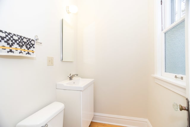 bathroom featuring vanity, toilet, and a wealth of natural light