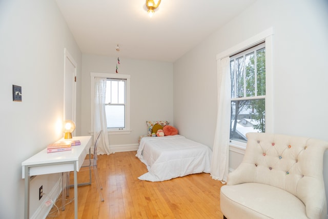 bedroom featuring hardwood / wood-style flooring and multiple windows