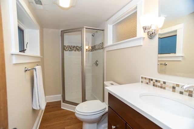 bathroom featuring hardwood / wood-style floors, a chandelier, an enclosed shower, toilet, and vanity