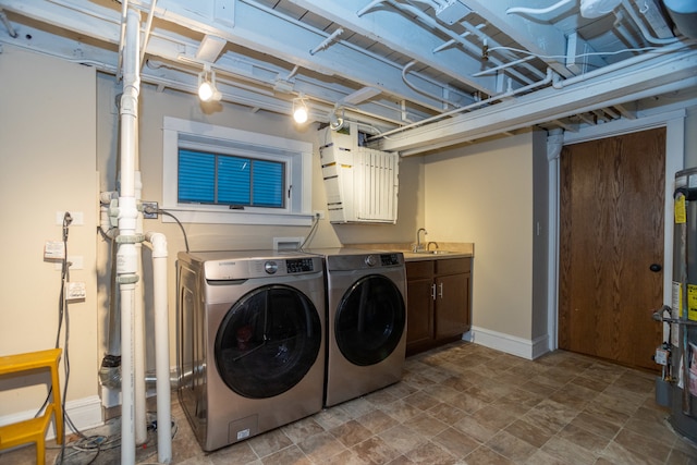 clothes washing area with separate washer and dryer and sink