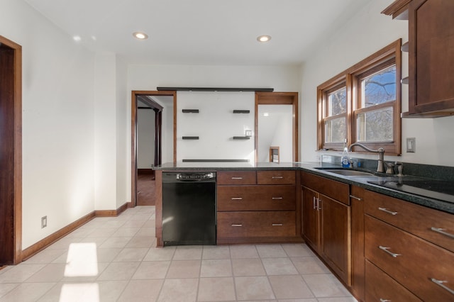 kitchen featuring dishwasher, sink, dark stone countertops, cooktop, and kitchen peninsula