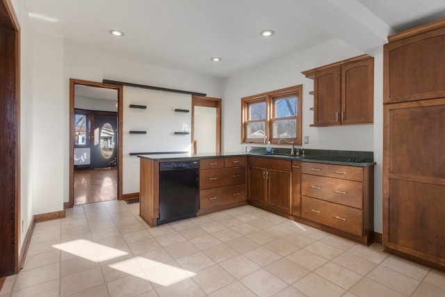 kitchen with sink, black dishwasher, kitchen peninsula, dark stone counters, and light tile patterned flooring