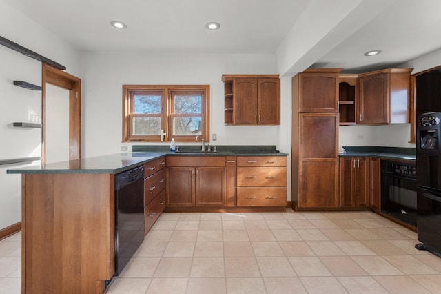 kitchen with dark stone countertops, sink, light tile patterned floors, and black appliances