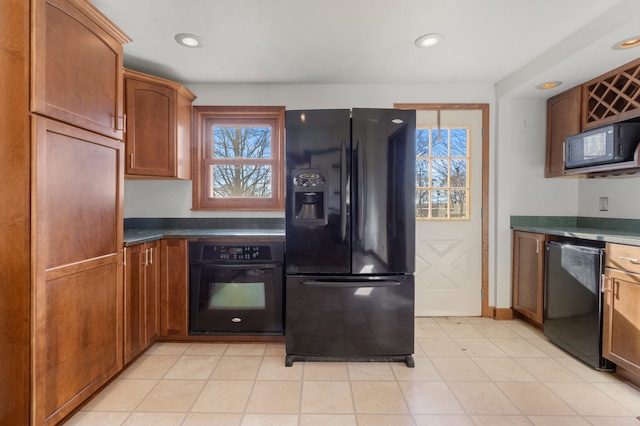 kitchen featuring a wealth of natural light and black appliances