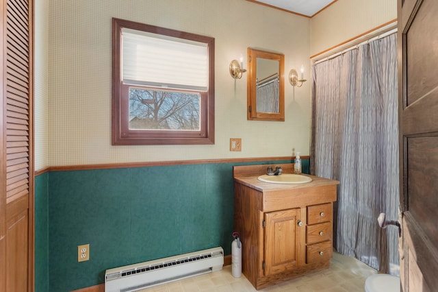 bathroom featuring vanity, toilet, and a baseboard heating unit