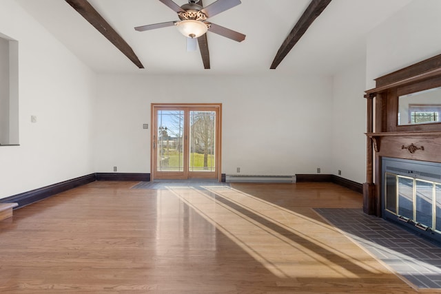 unfurnished living room with beam ceiling, a tile fireplace, ceiling fan, a baseboard radiator, and dark hardwood / wood-style floors