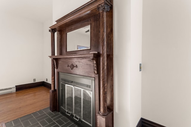 room details with wood-type flooring and a baseboard heating unit