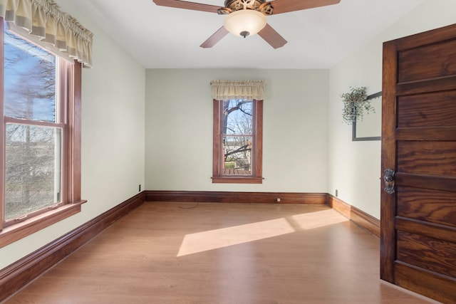 spare room featuring light hardwood / wood-style floors and ceiling fan