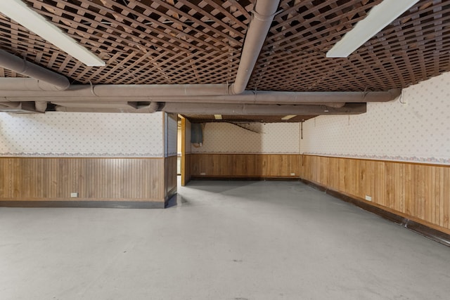 basement featuring wooden walls