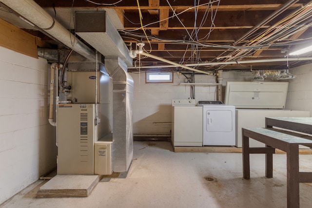 basement with separate washer and dryer, refrigerator, and heating unit