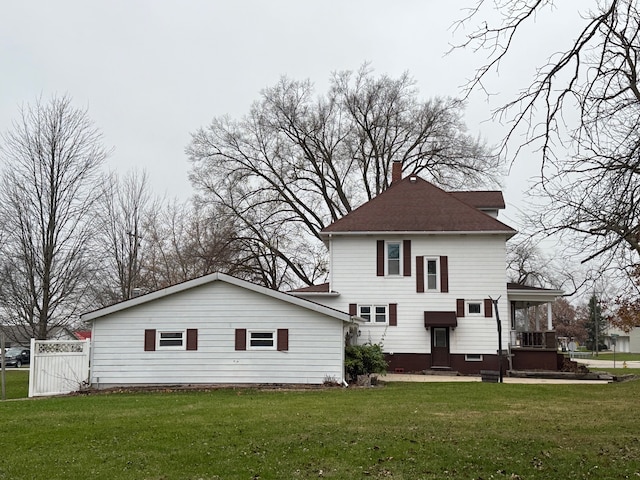 rear view of property with a yard