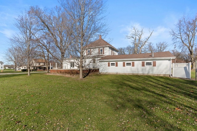 rear view of property with a lawn