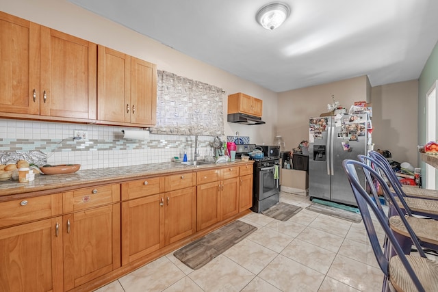 kitchen with light tile patterned flooring, sink, stainless steel refrigerator with ice dispenser, decorative backsplash, and gas stove