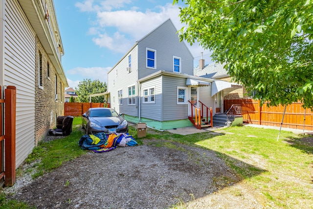 back of house featuring a yard