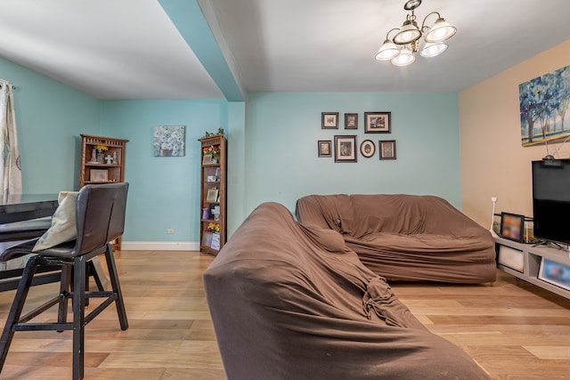 living room featuring light hardwood / wood-style floors and a notable chandelier