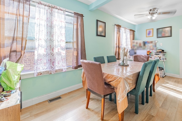 dining space with light wood-type flooring and ceiling fan