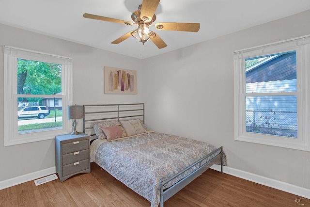 bedroom with hardwood / wood-style floors and ceiling fan