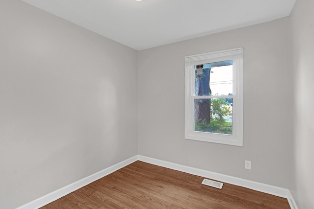 unfurnished room featuring hardwood / wood-style floors