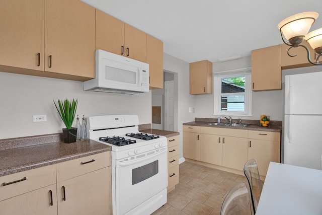 kitchen with light brown cabinets, white appliances, and sink